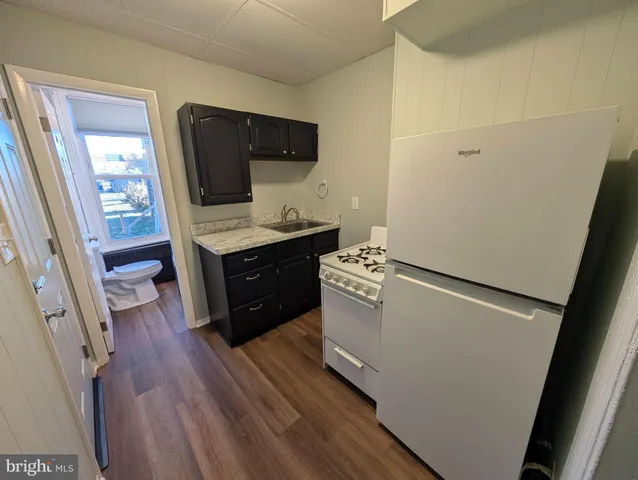 a room with wooden floor and furniture
