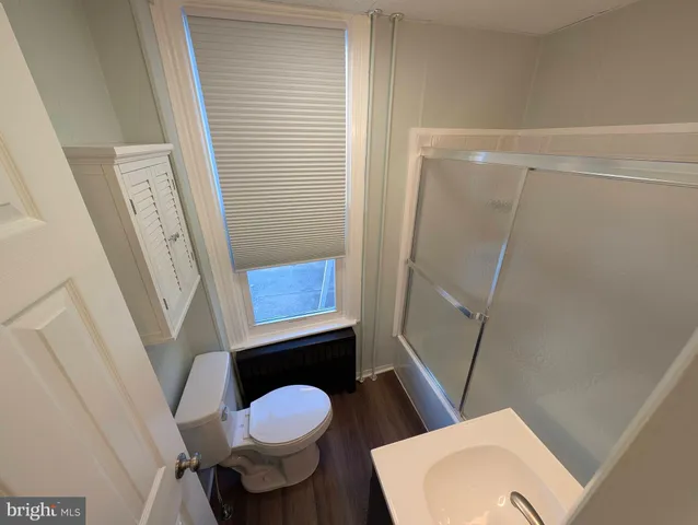 a bathroom with a toilet and a shower