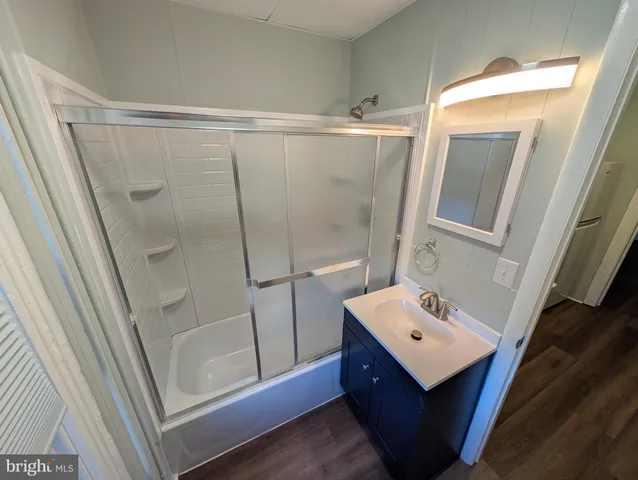 a bathroom with a sink a mirror and shower