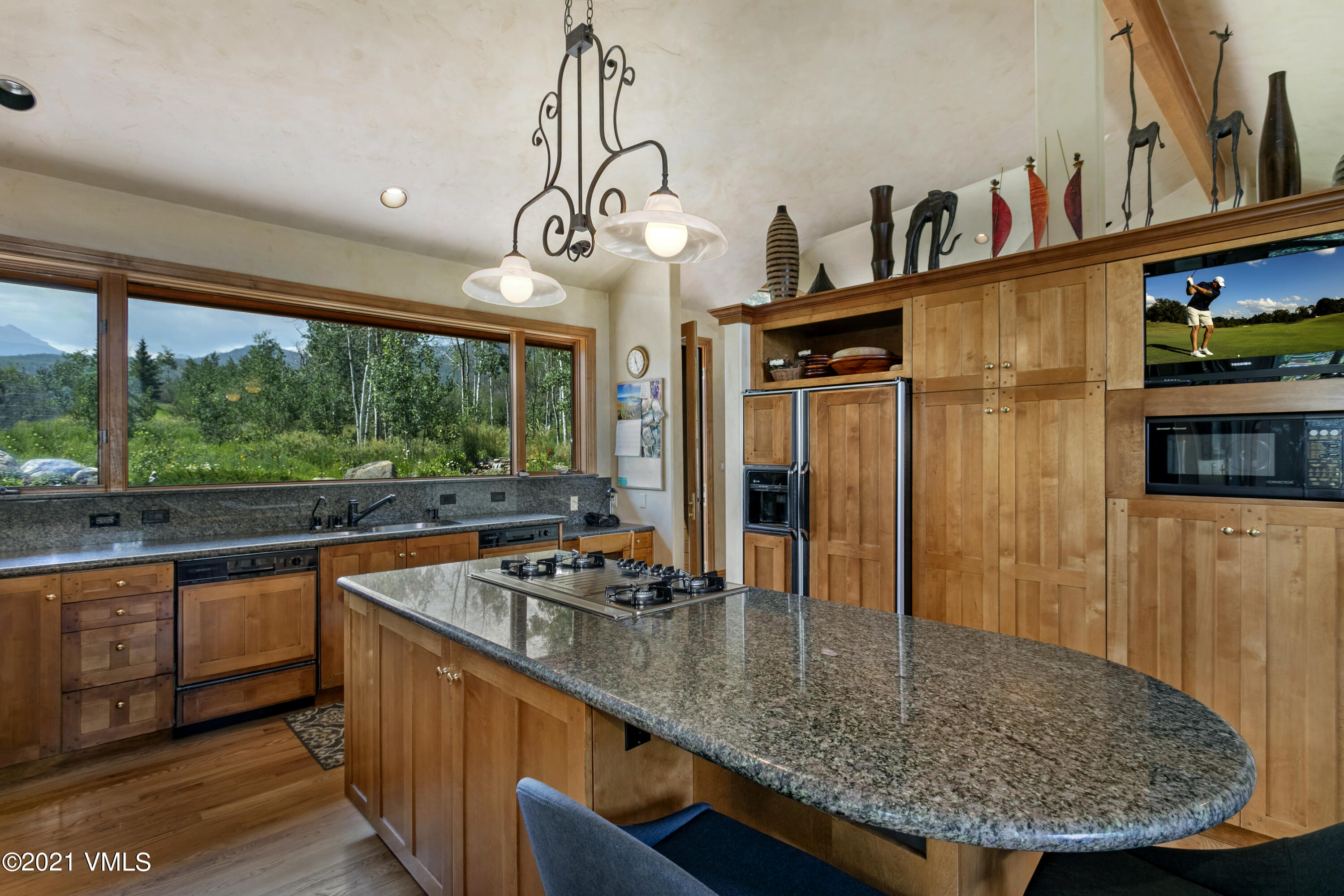755 Eagle Crest Road Edwards, CO 81632 - Photo 12 of 56 a kitchen with stainless steel appliances granite countertop a sink a stove and a wooden cabinets