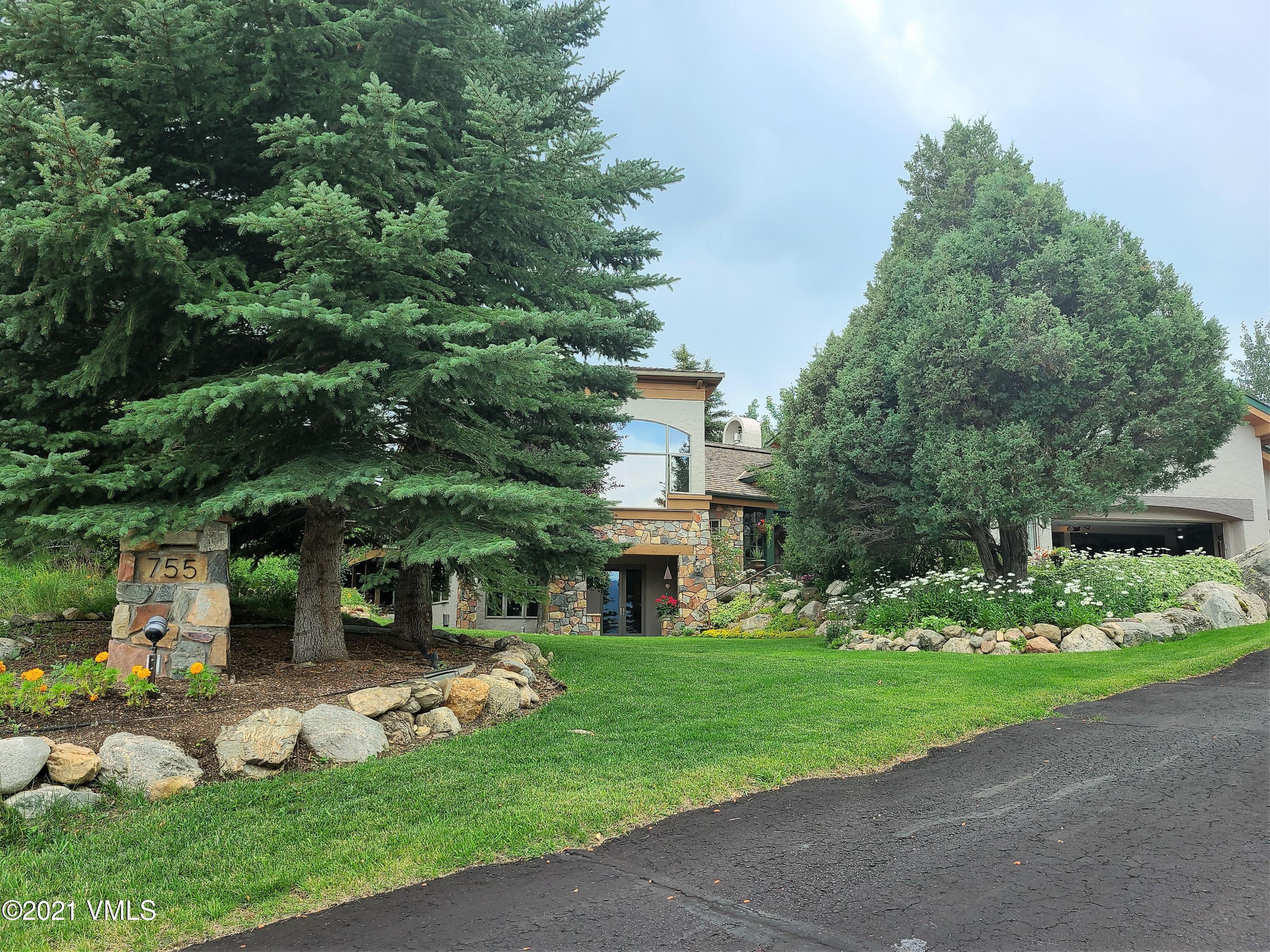 755 Eagle Crest Road Edwards, CO 81632 - Photo 2 of 56 a front view of a house with a yard table and chairs