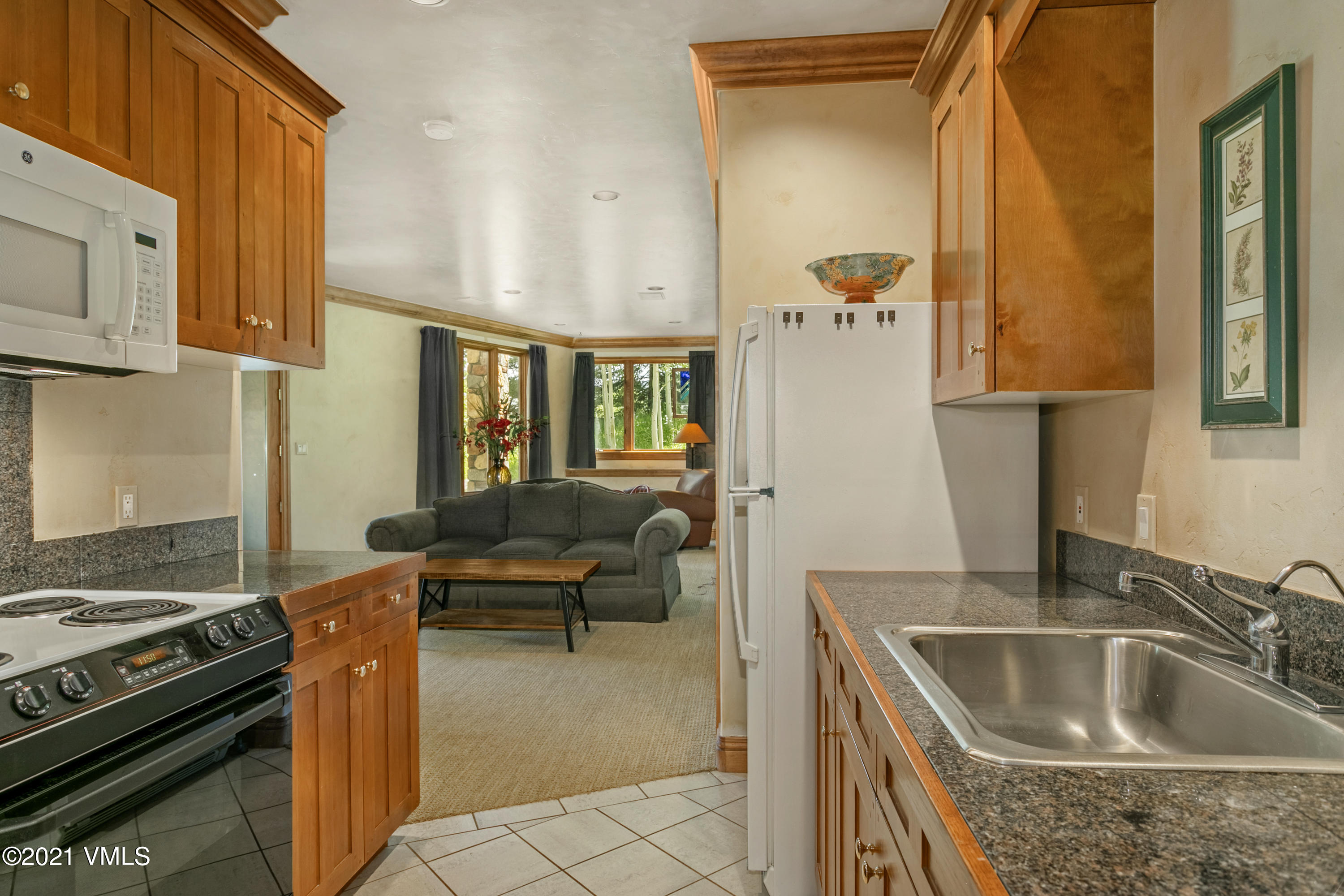 755 Eagle Crest Road Edwards, CO 81632 - Photo 34 of 56 a kitchen with a sink stove and a refrigerator