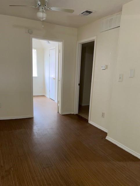 8127 Stonehurst Street, Unit 9 Dallas, TX 75217 - Photo 1 of 12 an empty room with wooden floor and chandelier fan
