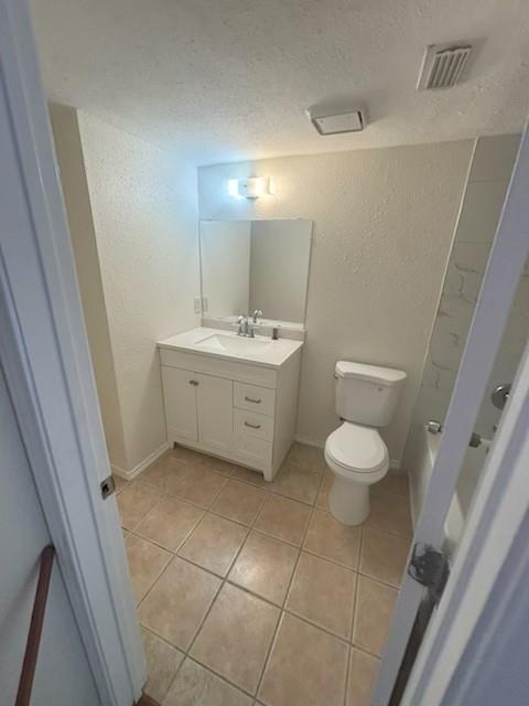 8127 Stonehurst Street, Unit 9 Dallas, TX 75217 - Photo 11 of 12 a bathroom with a sink a toilet and a mirror