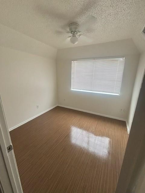 8127 Stonehurst Street, Unit 9 Dallas, TX 75217 - Photo 3 of 12 an empty room with wooden floor and windows