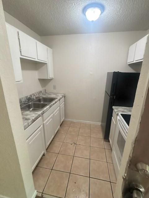 8127 Stonehurst Street, Unit 9 Dallas, TX 75217 - Photo 5 of 12 a kitchen with a sink a stove and cabinets