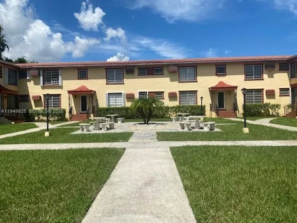 a front view of building with yard and green space