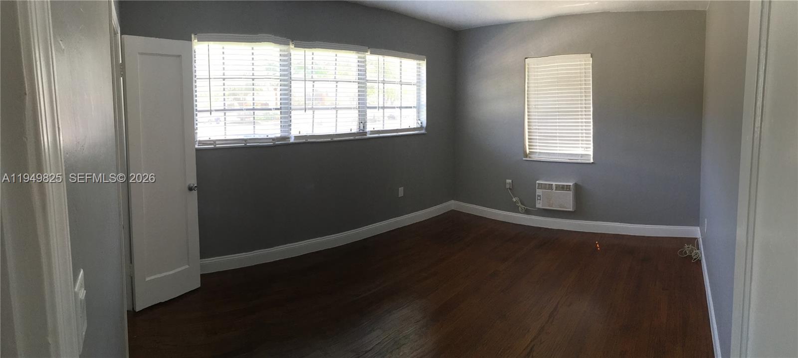 661 Southwest 11th Street, Unit 22W Miami, FL 33129 - Photo 11 of 22 an empty room with wooden floor and windows