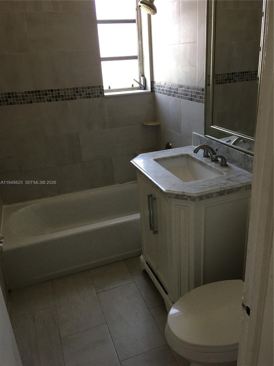 661 Southwest 11th Street, Unit 22W Miami, FL 33129 - Photo 13 of 22 a bathroom with a sink and a mirror