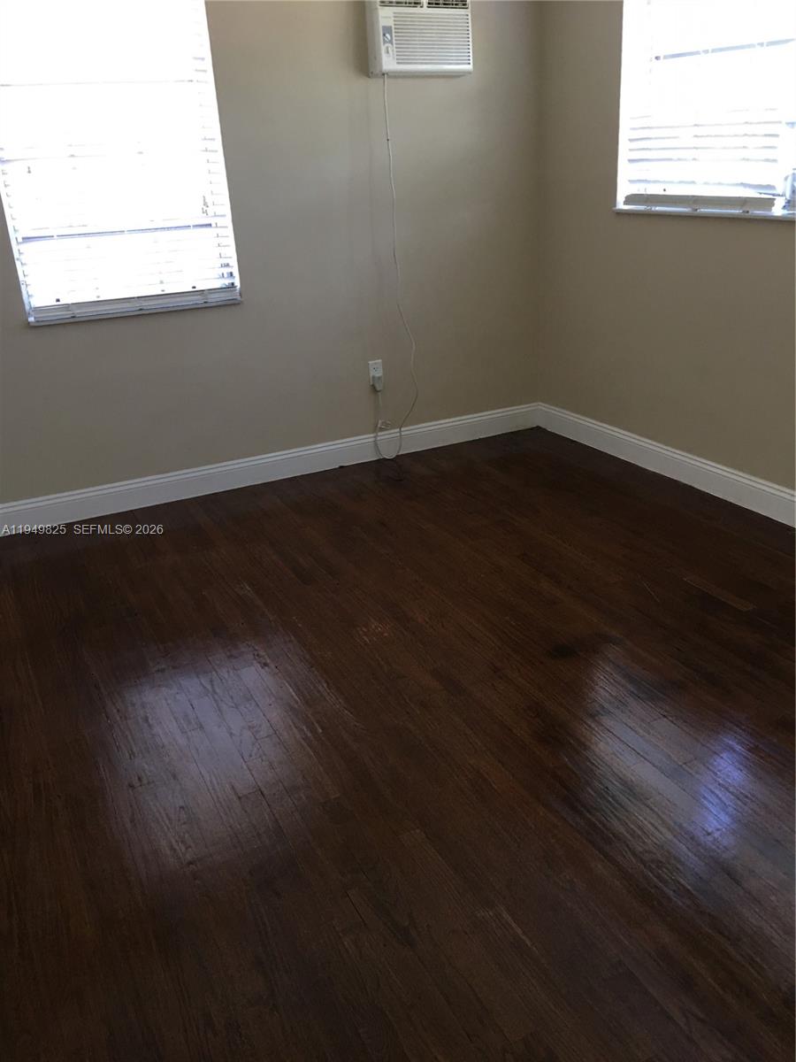 661 Southwest 11th Street, Unit 22W Miami, FL 33129 - Photo 21 of 22 an empty room with wooden floor and windows