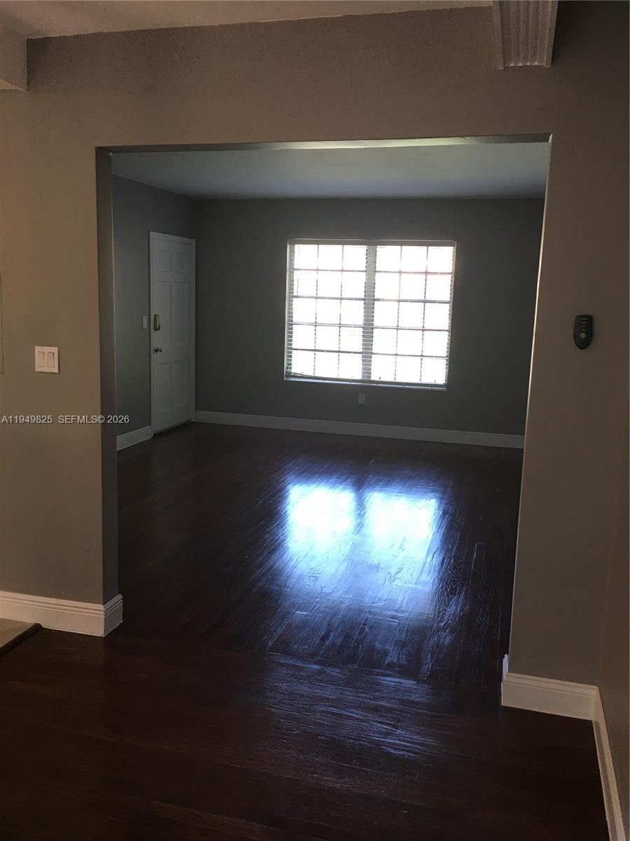 661 Southwest 11th Street, Unit 22W Miami, FL 33129 - Photo 5 of 22 wooden floor in an empty room with a window