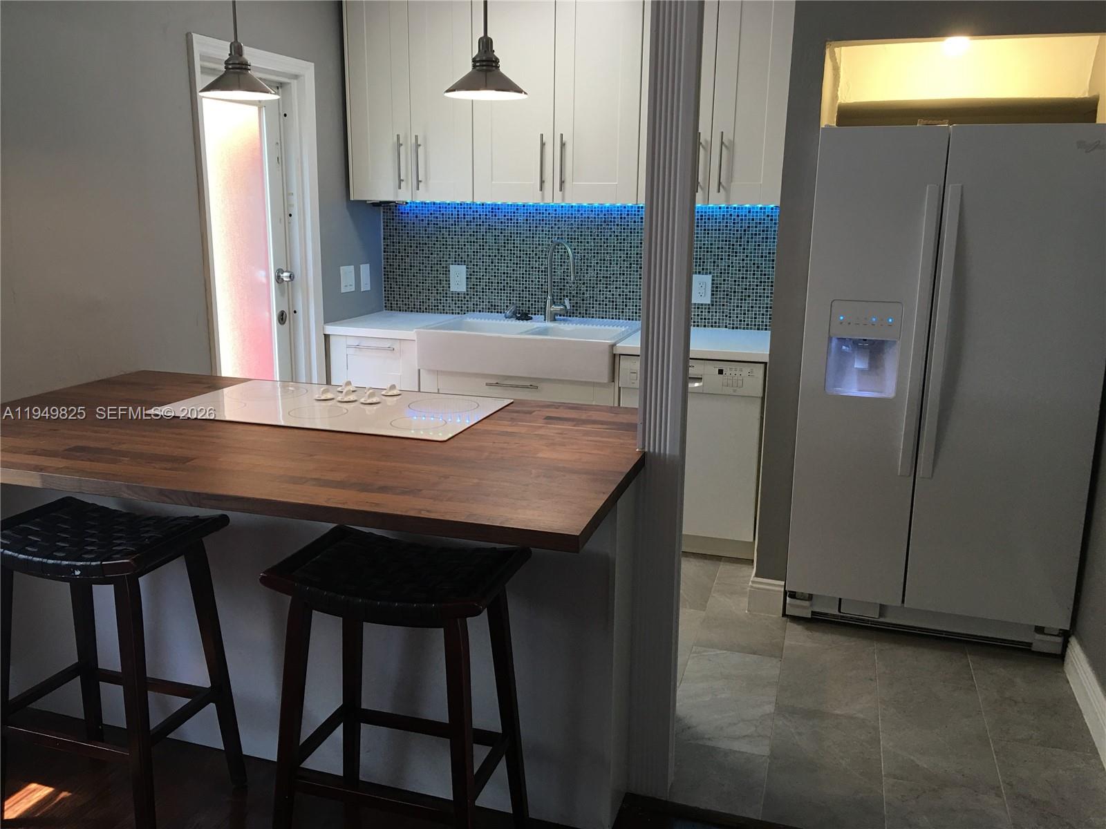 661 Southwest 11th Street, Unit 22W Miami, FL 33129 - Photo 10 of 22 a view of a kitchen area with furniture and wooden floor