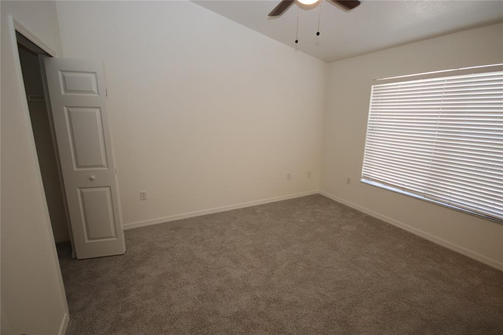 1575 Blue Magnolia Road Brandon, FL 33510 - Photo 11 of 22 an empty room with a window and a ceiling fan