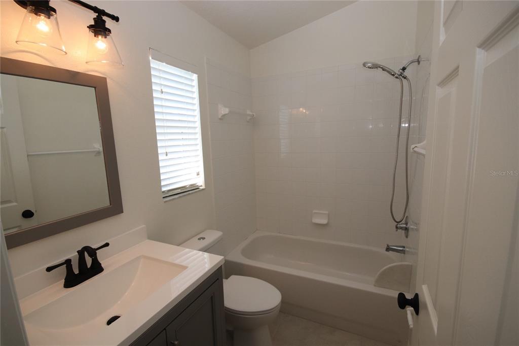 1575 Blue Magnolia Road Brandon, FL 33510 - Photo 15 of 22 a bathroom with a sink a toilet and shower
