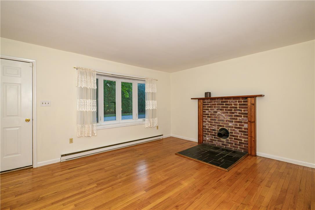 1644 9th Street Bethlehem, PA 18020 - Photo 2 of 27 A classic brick fireplace with a wood mantel offers warmth and character to this inviting space.