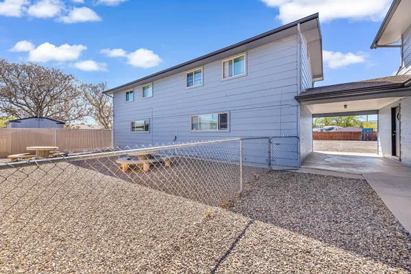a view of a patio with table and chairs and potted plants