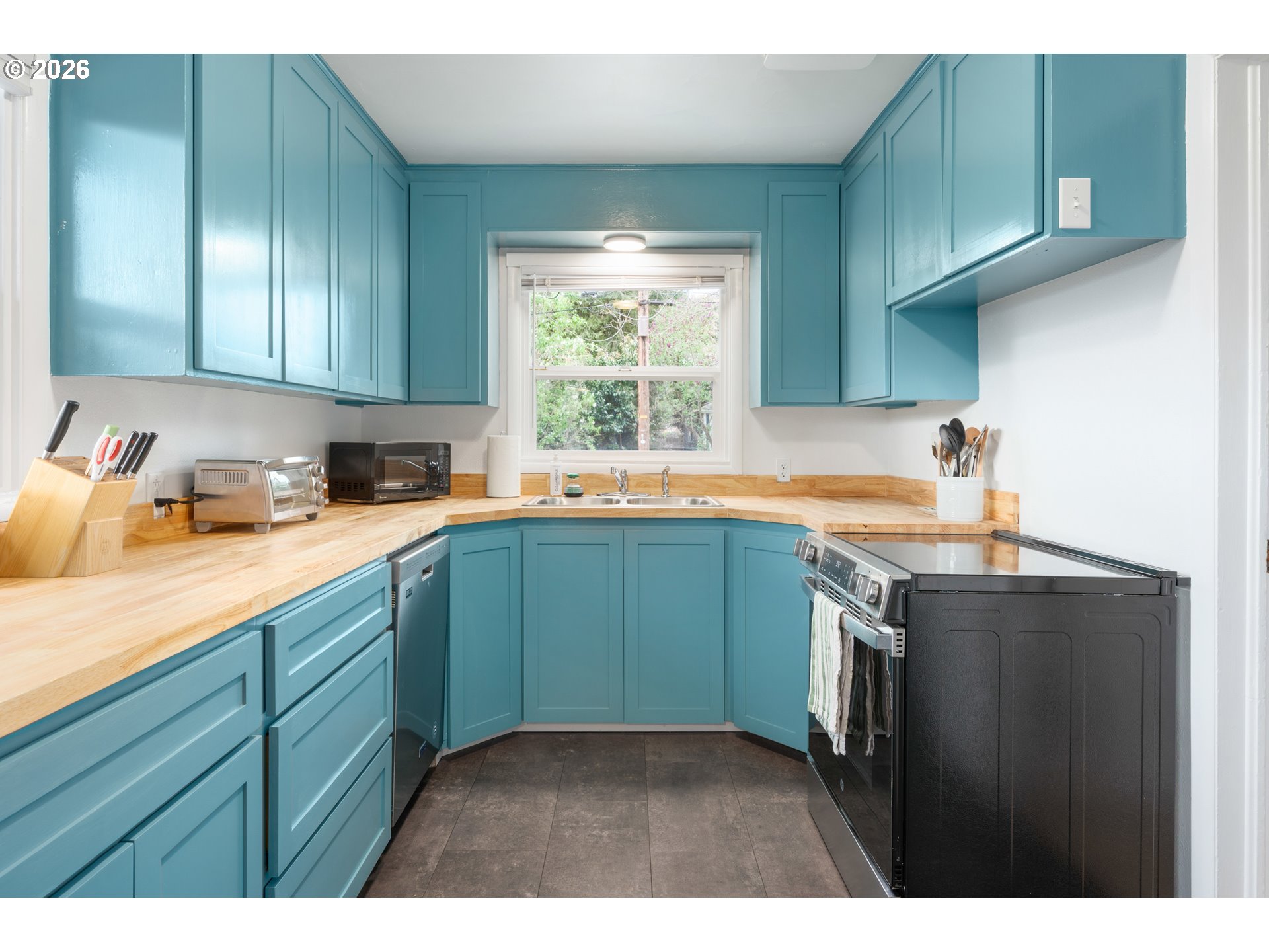 1280 Bailey Avenue Eugene, OR 97402 - Photo 11 of 42 a kitchen with stainless steel appliances granite countertop a sink stove and cabinets