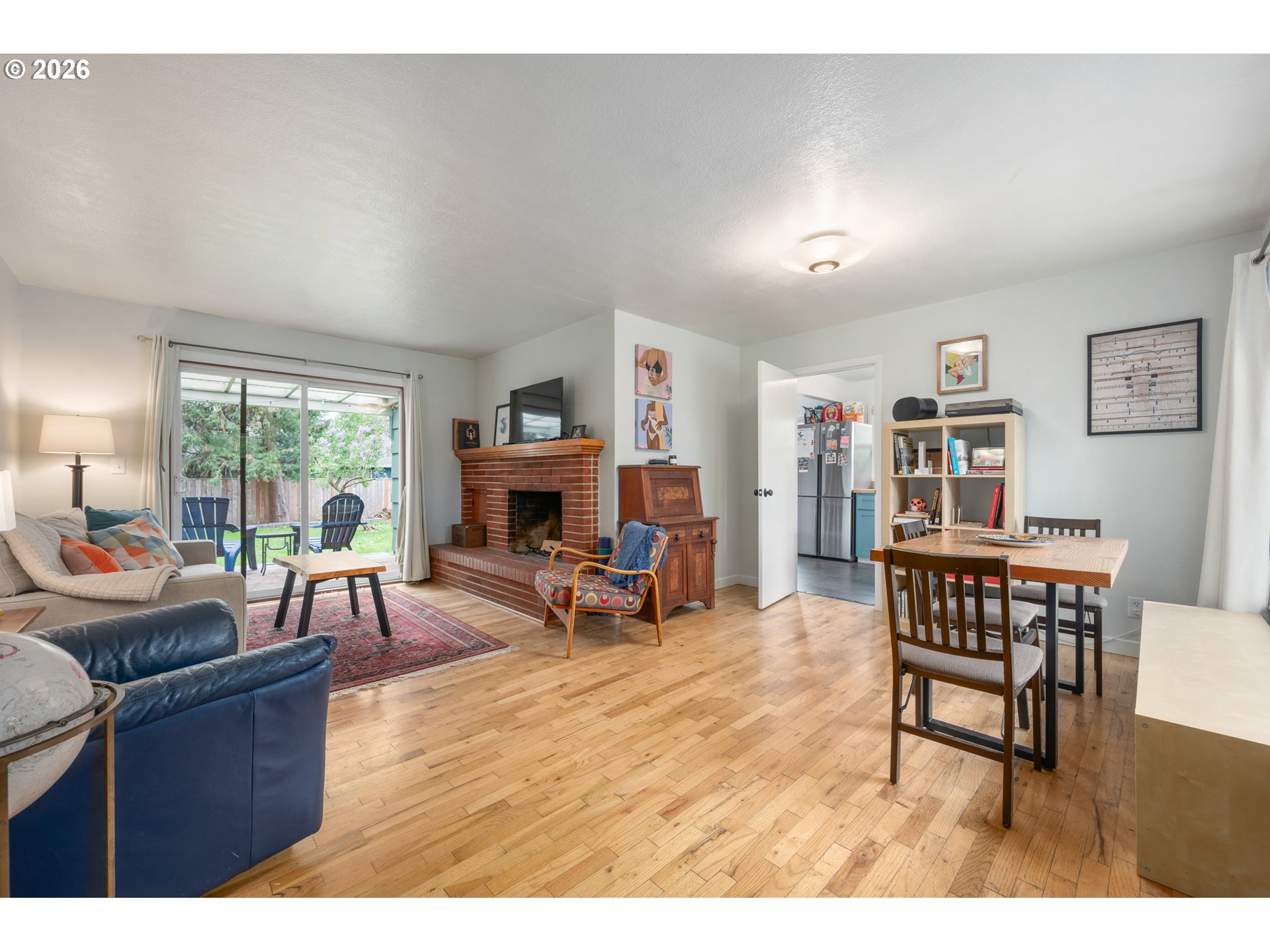 1280 Bailey Avenue Eugene, OR 97402 - Photo 5 of 42 a living room with furniture a fireplace and a large window