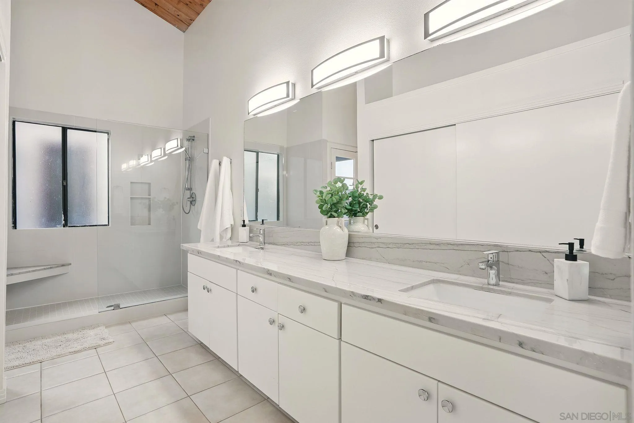 13883 Recuerdo Drive Del Mar, CA 92014 - Photo 15 of 45 a spacious bathroom with a granite countertop sink and a mirror