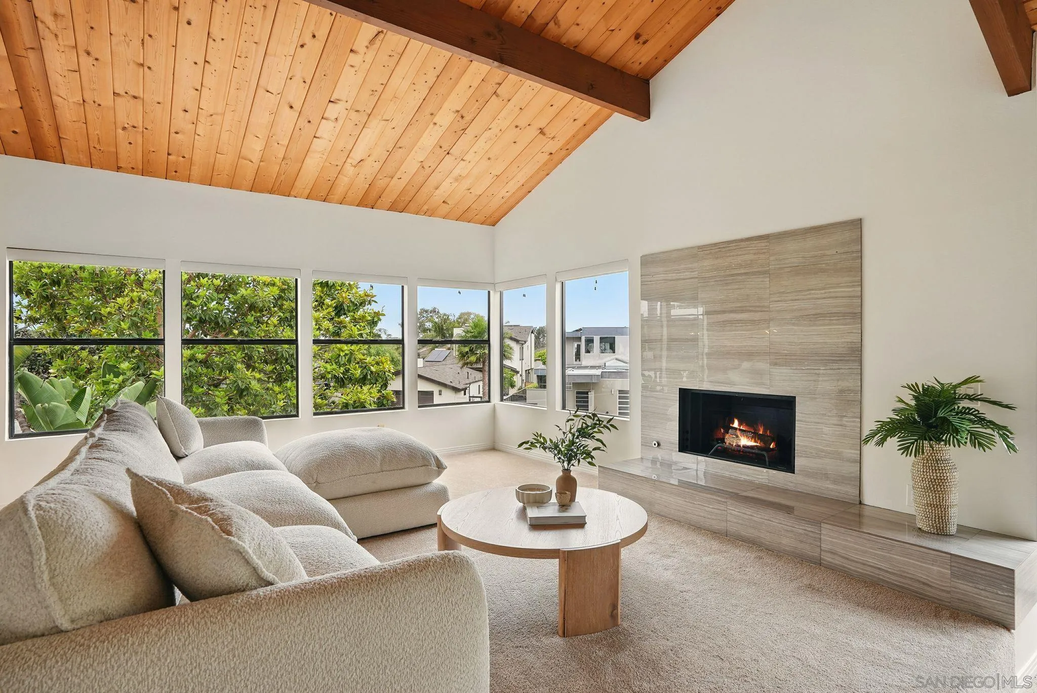 13883 Recuerdo Drive Del Mar, CA 92014 - Photo 2 of 45 a living room with furniture a fireplace and a floor to ceiling window