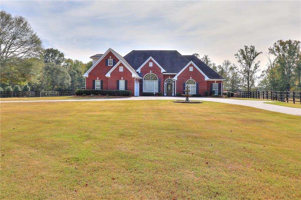 2880 Tig Knight Road Loganville, GA 30052 - Photo 1 of 1 a front view of house with yard and lake view