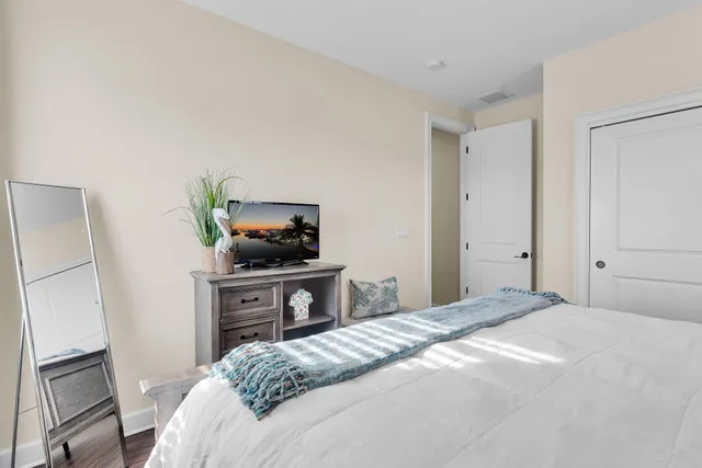 a bed room with a bed and a chair