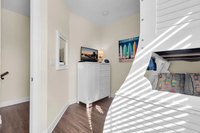 a view of a patio with couches table and chairs potted plants and palm tree