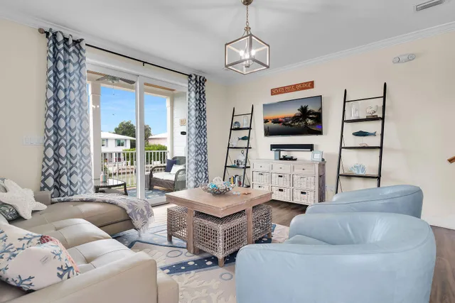 a living room with furniture a flat screen tv and a large window