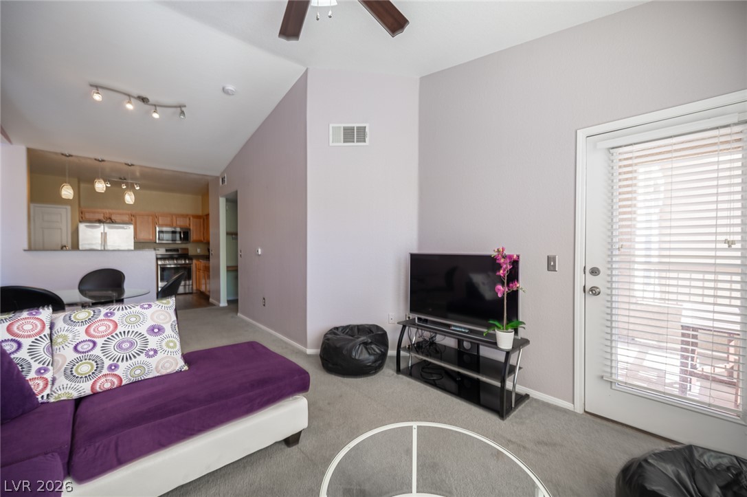 10550 West Alexander Road, Unit 2014 Las Vegas, NV 89129 - Photo 15 of 43 Vaulted ceilings and soft carpeting create a welcoming ambiance in this open living area.
