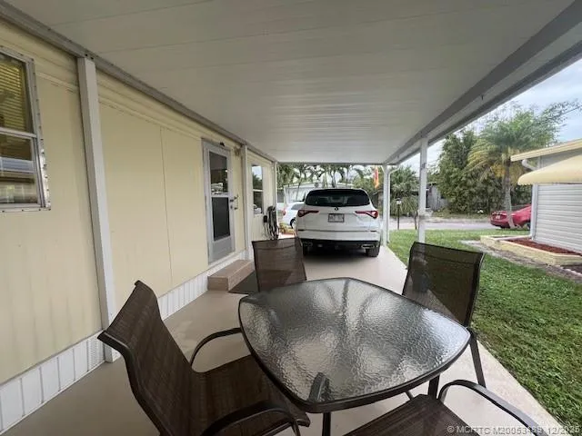 a view of a pathway of a house with a yard