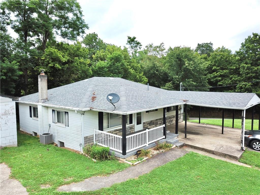 a aerial view of a house with a yard table and chairs