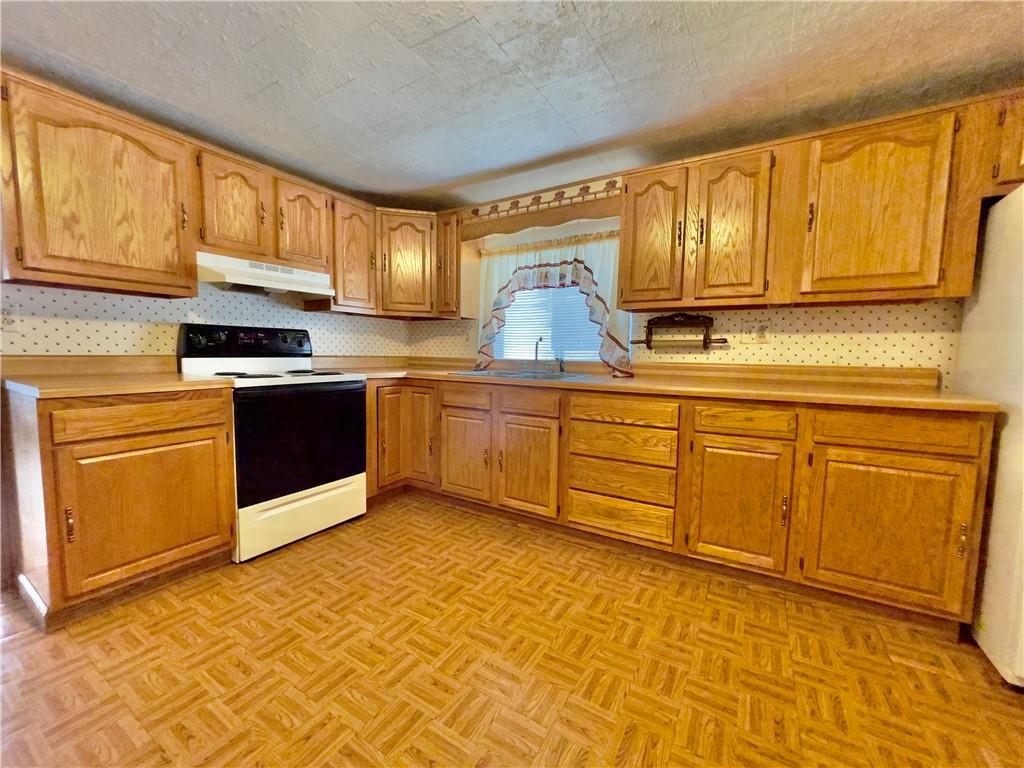 309 Moscow Road Waynesburg, PA 15370 - Photo 4 of 25 a kitchen with stainless steel appliances granite countertop a stove sink and cabinets