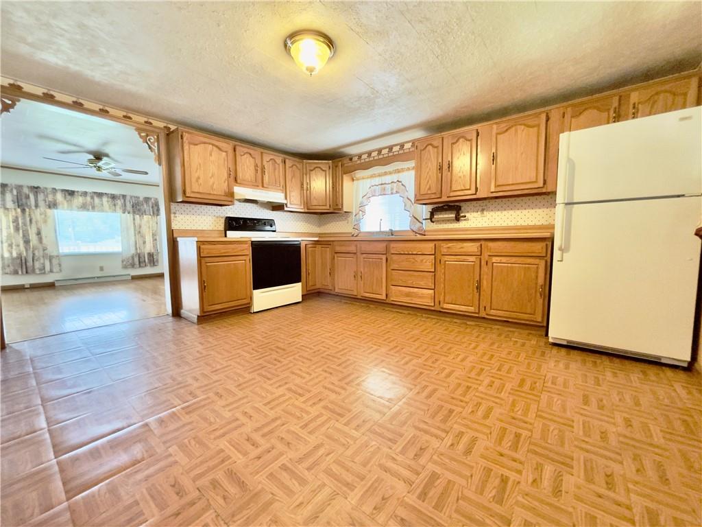 309 Moscow Road Waynesburg, PA 15370 - Photo 5 of 25 a kitchen with stainless steel appliances granite countertop a stove a sink and a refrigerator