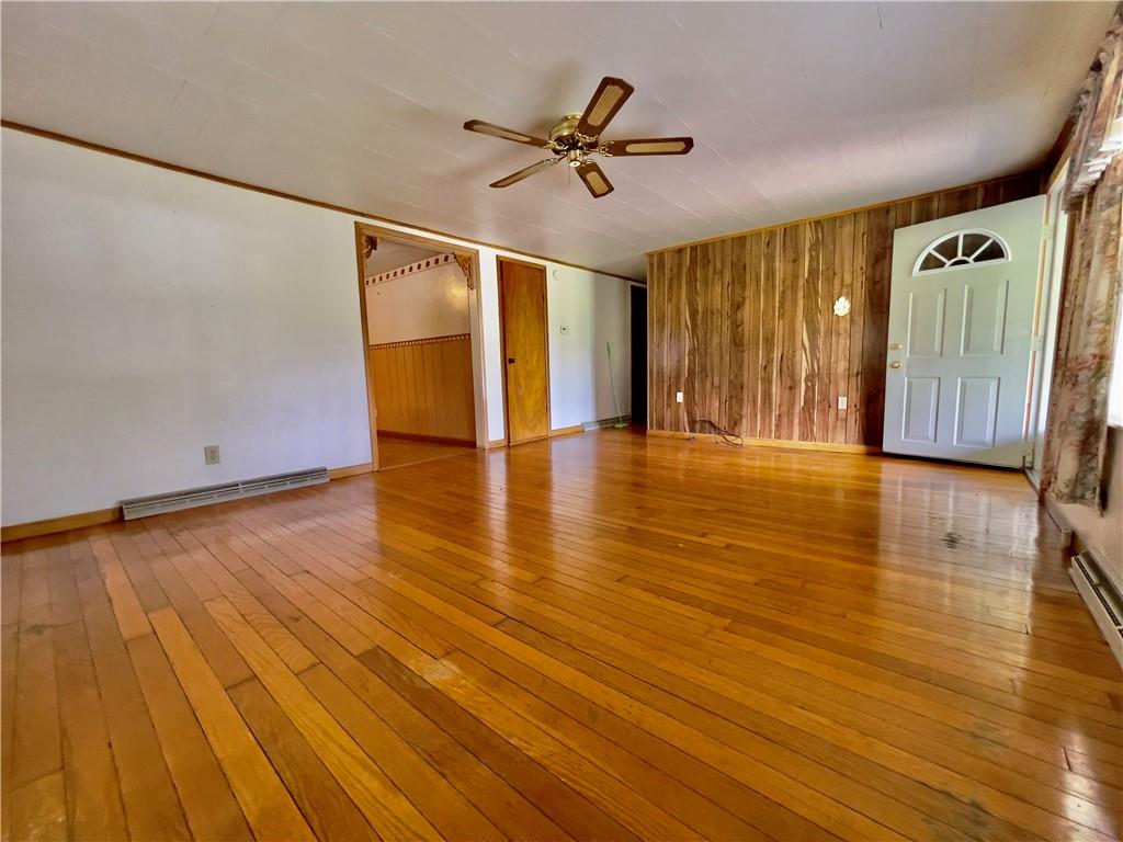 309 Moscow Road Waynesburg, PA 15370 - Photo 9 of 25 a view of an empty room with a window and wooden floor