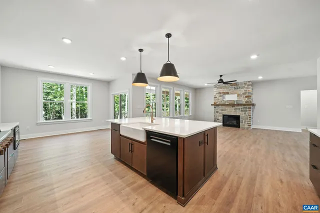 a kitchen with stainless steel appliances granite countertop a sink refrigerator and cabinets