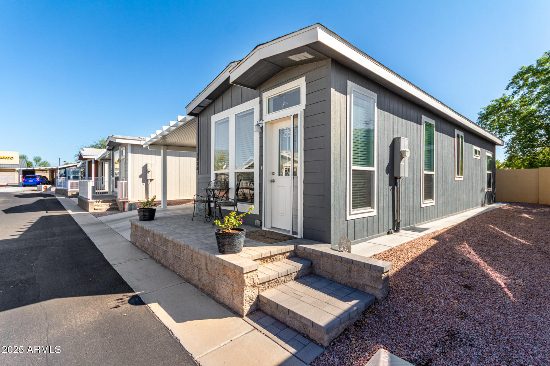 2206 South Ellsworth Road, Unit 103B Mesa, AZ 85209 - Photo 3 of 27 a view of a house with backyard and sitting area