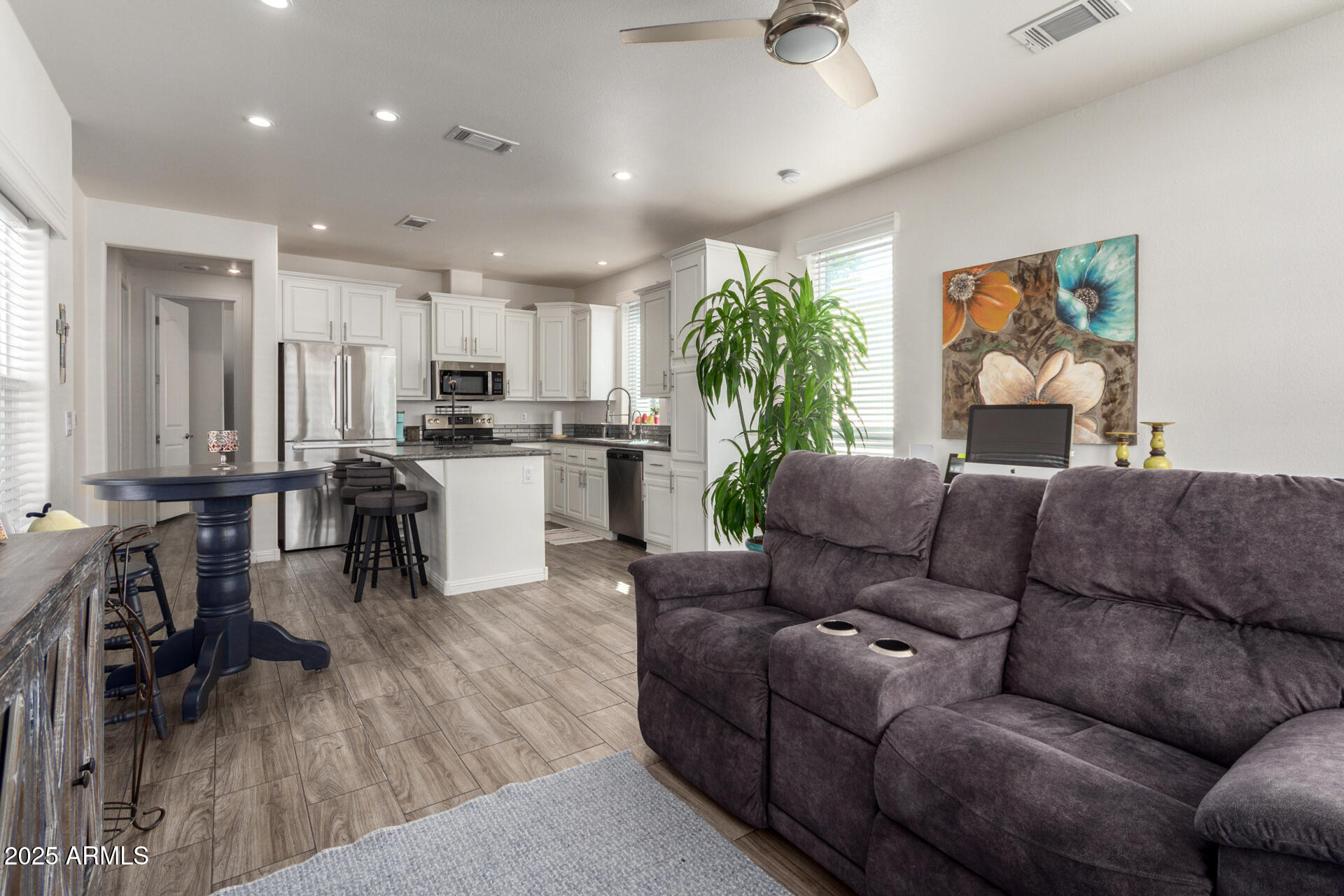 2206 South Ellsworth Road, Unit 103B Mesa, AZ 85209 - Photo 8 of 27 a living room with furniture and a wooden floor