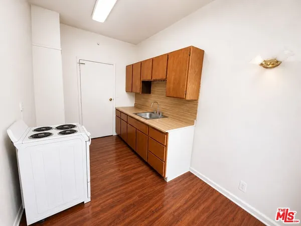 a kitchen with wooden cabinets and a stove