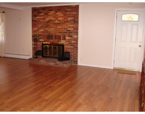 37 Kent Road Westminster, MA 01473 - Photo 5 of 19 a view of an empty room with wooden floor and a fireplace