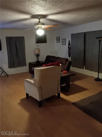 a living room with furniture and a mirror