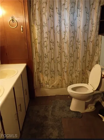 a bathroom with a toilet and a shower curtain