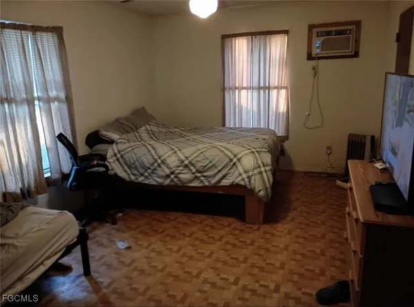 a bedroom with a bed closet and flat tv screen