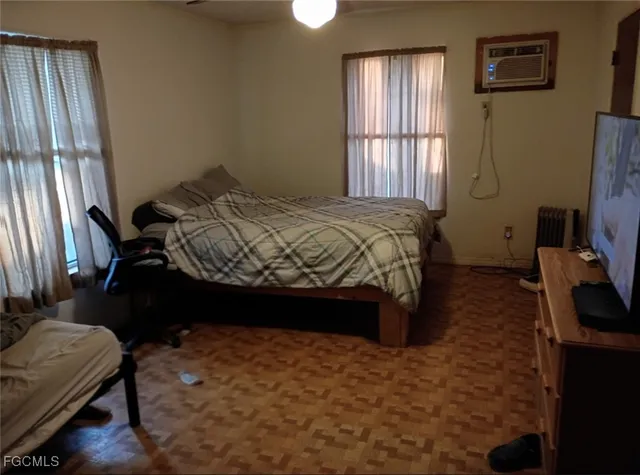 a bedroom with a bed closet and flat tv screen