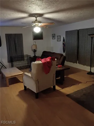 a living room with furniture and a mirror