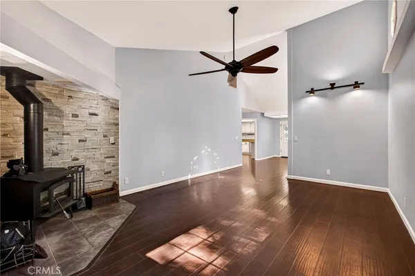 a view of livingroom with hardwood floor and a kitchen