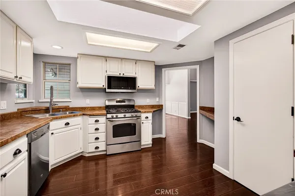 a kitchen with granite countertop a sink and cabinets