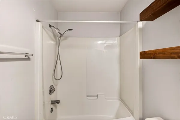a view of room with window and wooden floor