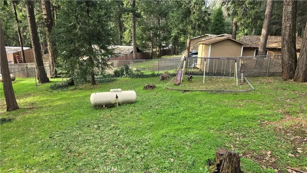a backyard of a house with barbeque oven