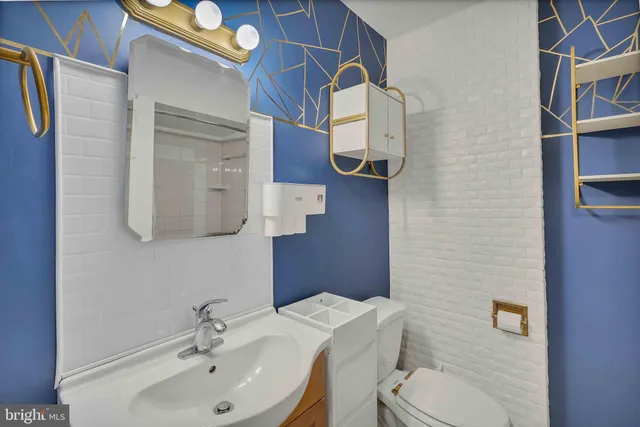 a bathroom with a sink toilet and mirror