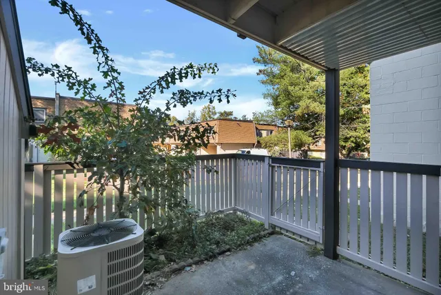 a view of a porch with furniture and floor to ceiling window